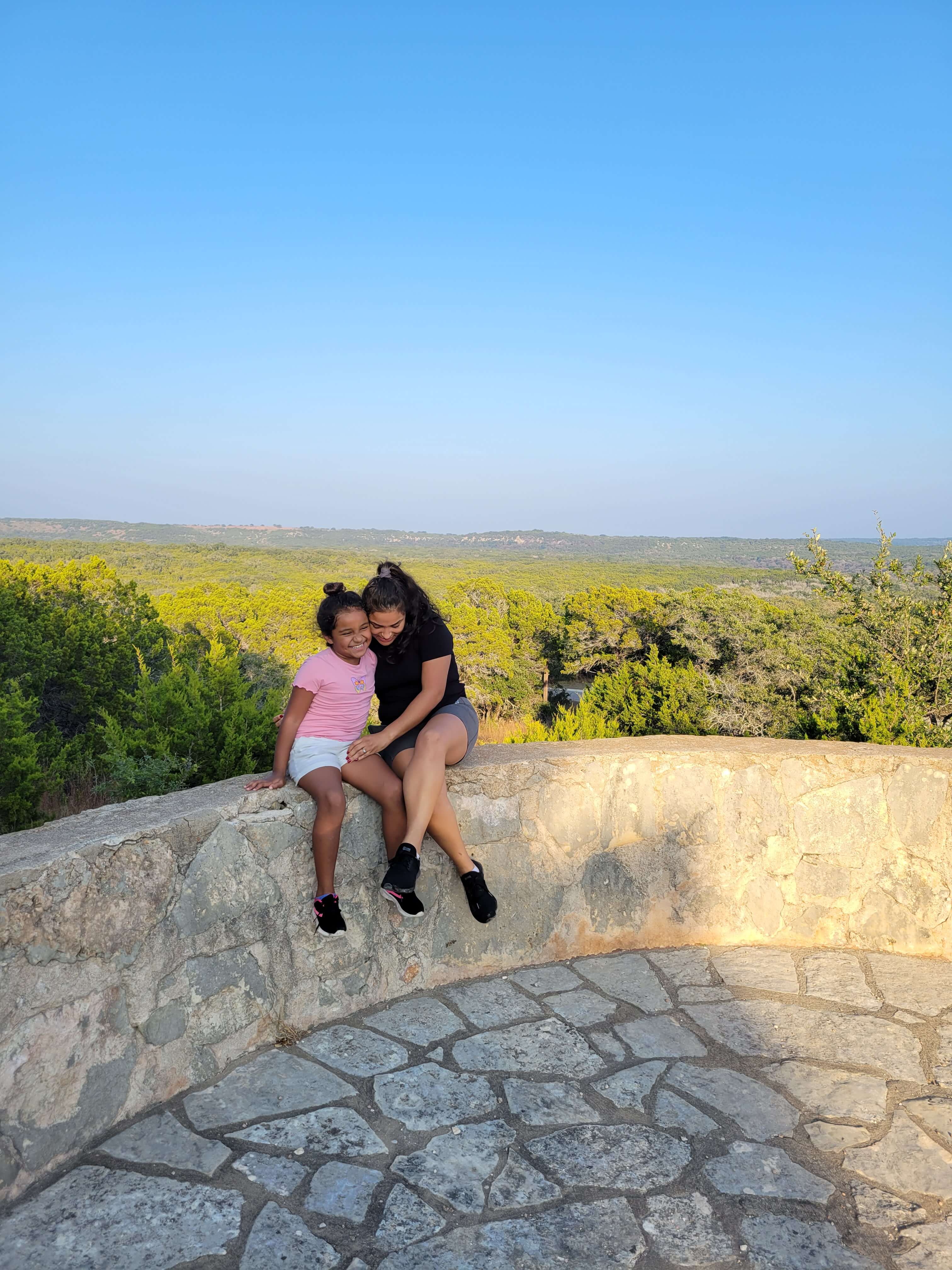 My wife and daughter on the wall at our camp suit.